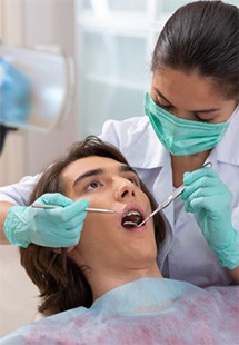 Teenager with brown hair in dental chair having checkup